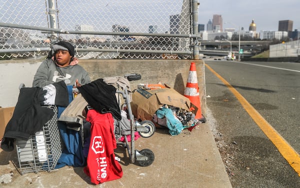 Pricilla Williams has been homeless since 2015 and spent the day near the on-ramp to the downtown connector on Fulton Street drying her wet clothes in the sun. Williams, interviewed in February, says she usually spends the night under bridges in the city of Atlanta and no longer has access to the medical care she needs for medications. At the time, the city was on the verge of a massive new effort to clear homeless people from living under bridges. (John Spink / John.Spink@ajc.com)

