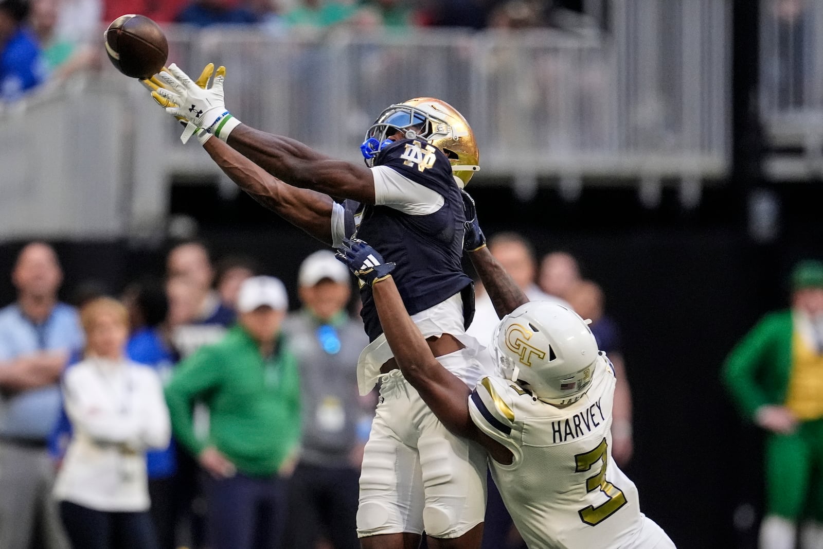 Notre Dame wide receiver Beaux Collins (5) misses the catch against Georgia Tech defensive back Ahmari Harvey (3) during the first half of an NCAA college football game, Saturday, Oct. 19, 2024, in Atlanta. (AP Photo/Mike Stewart)