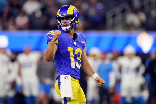 Los Angeles Rams quarterback Stetson Bennett (13) celebrates after a defensive holding call during the second half of a preseason NFL football game against the Los Angeles Chargers Saturday, Aug. 12, 2023, in Inglewood, Calif. (AP Photo/Ryan Sun)