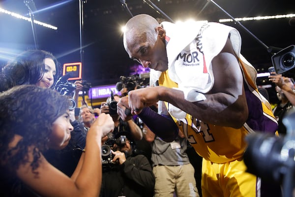 Los Angeles’ Kobe Bryant fist-bumps Gianna after the last NBA basketball game of his career.