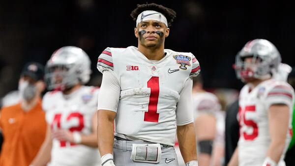 FILE -= Ohio State quarterback Justin Fields watches during the second half of the Sugar Bowl NCAA college football game against Clemson Friday, Jan. 1, 2021, in New Orleans. Fields is a likely first round pick in the NFL Draft, April 29-May 1, 2021, in Cleveland.(AP Photo/John Bazemore, File)