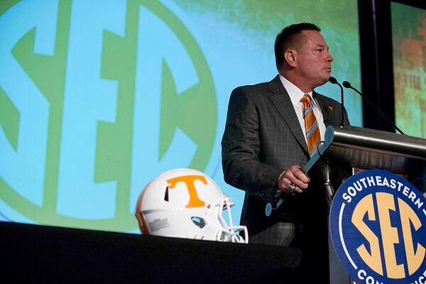 Butch Jones at the podium, helmet at the ready. (AP Photo/Brynn Anderson)