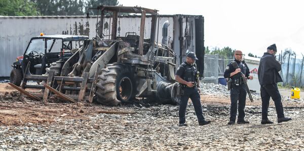 March 6, 2023 Atlanta: Atlanta police and construction personnel were on the construction site of the police training center Monday morning, March 6, 2023 in Atlanta examining equipment set on fire and destroyed by violent protests Sunday. Dozens of protesters dressed in all black threw large rocks, bricks, Molotov cocktails and fireworks at officers at the site on Sunday. City and state leaders and police condemned the violence that broke out Sunday, leaving construction equipment destroyed and 35 people detained. Georgia Gov. Brian Kemp on Monday said those involved put “destruction and vandalism” over “legitimate protest.” “As I’ve said before, domestic terrorism will NOT be tolerated in this state,” Kemp said in a statement. “As we continue to respect peaceful protest, we will also continue to ensure safety in our communities. We will not rest until those who use violence and intimidation for an extremist end are brought to full justice.” Meanwhile, an activist group called “Stop Cop City” said it was officers who started the violence by raiding a nearby music festival, a news release from the group states. Some of the violence at the Atlanta Public Safety Training Center site, located near Bouldercrest Road and Key Road in DeKalb County, was captured on surveillance cameras and released by Atlanta police. Several pieces of construction equipment were set on fire, Atlanta police Chief Darin Schierbaum said during a news conference late Sunday. Other police agencies stepped in to assist the city’s officers.(John Spink / John.Spink@ajc.com)

