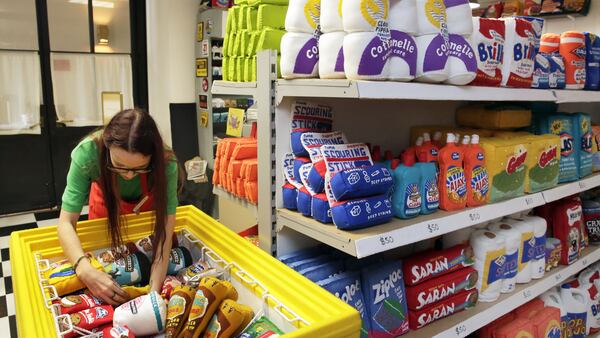 British artist Lucy Sparrow straightens items in an ice cream freezer case of her all-felt model of a New York City bodega, in New York, Monday, June 5, 2017. Her 1,200-square-foot model of a bodega, which opens to the public in Manhattan on Monday, includes plush versions of deli staples like candy bars, cigarettes, canned beans and other items. (AP Photo/Richard Drew)