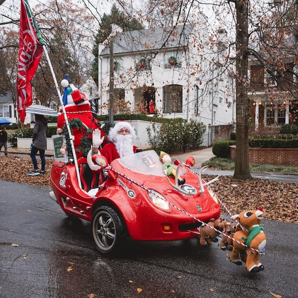 Santa waves from his sleigh while being a part of the Winterfest holiday parade in Virginia Highland. (Virginia Highland District Facebook)