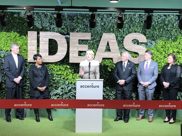 Julie Sweet (center), then the North American CEO for Accenture, speaks Dec. 12, 2018, before a formal ribbon cutting for the global consulting group’s new technology hub at Technology Square in Midtown. Today, Sweet is the CEO of the global consulting firm. Standing from left to right were then-Georgia Tech President Bud Peterson, then-Atlanta Mayor Keisha Lance Bottoms, then- Gov. Nathan Deal and state Department of Economic Development Commissioner Pat Wilson. J. SCOTT TRUBEY/AJC