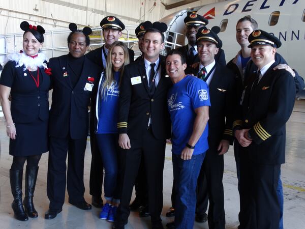 The Bert Show poses with the ExpressJet pilots. CREDIT: Rodney Ho/ rho@ajc.com