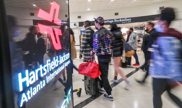 Thanksgiving travelers contributed to Hartsfield-Jackson International Airport regaining its world busiest airport designation. Hartsfield-Jackson’s passenger counts in 2021 were up 76.4% from 2020, but still down nearly one-third from 2019. Since the retreat of the omicron variant earlier this year, domestic traffic has been nearing 2019 levels. ( John Spink / John.Spink@ajc.com)

