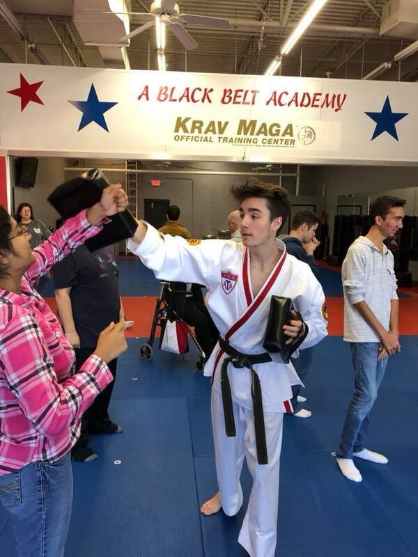 Marcus McAbee (right) gives one-on-one instruction to a student during a recent workshop at Kennesaw Mountain High School. CONTRIBUTED