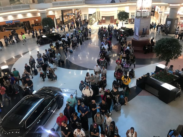 Memorial Day weekend travel is in full swing at Hartsfield-Jackson International Airport. Security lines for the main checkpoint stretched through the domestic terminal atrium and began extending into baggage claim by 7:30 a.m. Friday, May 24, 2019. (Photo: Kelly Yamanouchi/AJC)