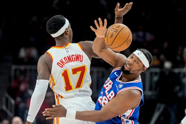 Philadelphia 76ers forward Guerschon Yabusele (28) and Atlanta Hawks forward Onyeka Okongwu (17) for for a loose ball during the first half of an NBA basketball game, Monday, March 10, 2025, in Atlanta. (AP Photo/Mike Stewart)