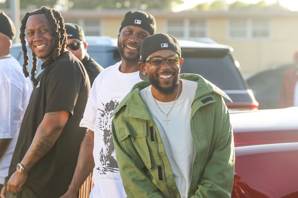 Kendrick Lamar smiles alongside Jay Rock, center, in between filming for the the music video for "Not Like Us" at Nickerson Gardens on June 22, 2024, in Watts, California. (Michael Blackshire/Los Angeles Times/TNS)