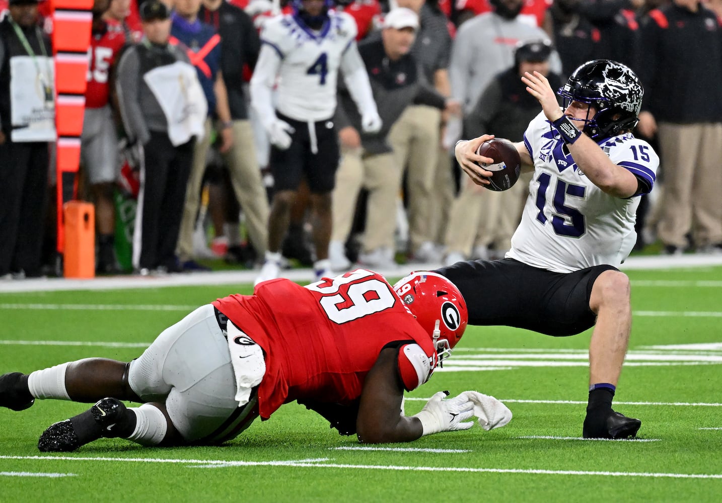 TCU Horned Frogs quarterback Max Duggan (15) is sacked by Georgia Bulldogs defensive lineman Bear Alexander (99) during the first half of the College Football Playoff National Championship at SoFi Stadium in Los Angeles on Monday, January 9, 2023. (Hyosub Shin / Hyosub.Shin@ajc.com)