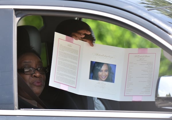 A mourner shows off the Bobbi Kristina funeral program to the media as they depart. CREDIT: Hyosub Shin/ ajc.com