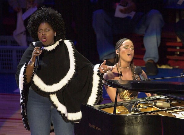 FILE - Alicia Keys, right, and Angie Stone, perform "America the Beautiful" during the NBA All-Star game in Philadelphia, Feb. 10, 2002. (AP Photo/Dan Loh, file)