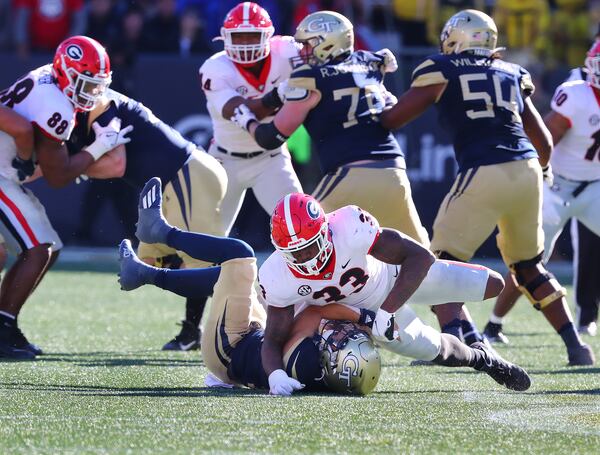 Georgia outside linebacker Robert Beal Jr. sacks Georgia Tech quarterback Jordan Yates on a 4th down attempt during the fourth quarter as Georgia shuts out the Yellow Jackets 45-0 in a NCAA college football game on Saturday, Nov. 27, 2021, in Atlanta.   “Curtis Compton / Curtis.Compton@ajc.com”`