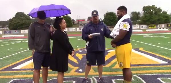 Murray State defensive lineman Bishop Woods and his fiancee Caitlin Myers were married at midfield.