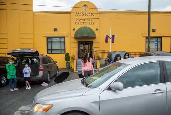 Volunteers with the Compassion Kitchen Project hand out Easter meals to families in need at The Mission church in Atlanta on Thursday March 25th, 2021. PHIL SKINNER FOR THE ATLANTA JOURNAL-CONSTITUTION.