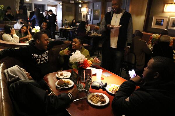 People attend Ludacris’ late night party at the Hotel Clermont in Atlanta early Friday morning. Chicken+Beer food was served to the guests. EMILY HANEY / EMILY.HANEY@AJC.COM