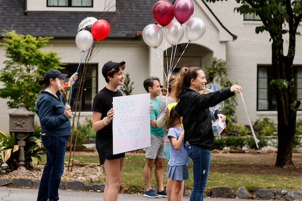 Parents and students gather to surprise Atlanta Public Schools bus driver Alma Jennings along her bus route on Monday, May 23, 2022. (Natrice Miller / natrice.miller@ajc.com)