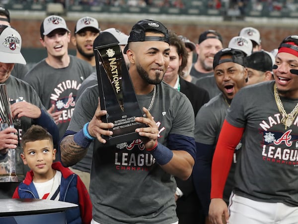 Braves' Eddie Rosario holds the NLCS MVP trophy after helping his team beat the Dodgers on Oct. 23 in Atlanta. (Curtis Compton / Curtis.Compton@ajc.com)