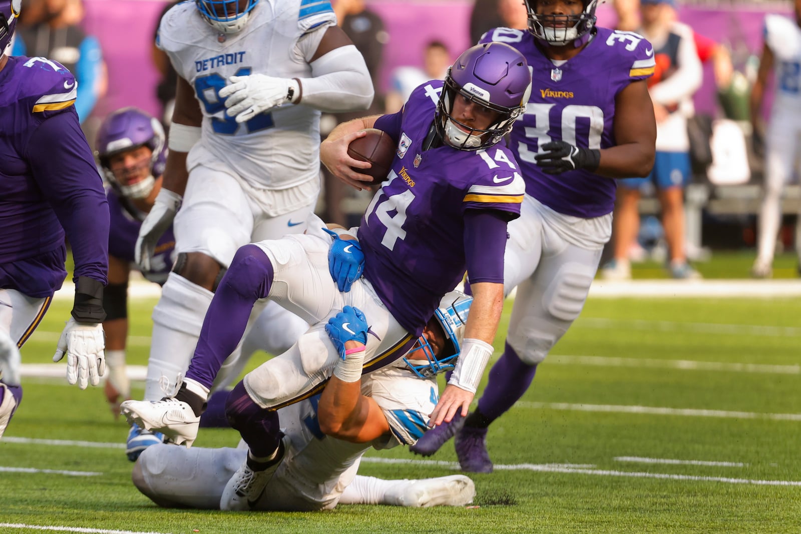 Detroit Lions linebacker Malcolm Rodriguez (44) brings down Minnesota Vikings quarterback Sam Darnold (14) during the second half of an NFL football game Sunday, Oct. 20, 2024, in Minneapolis. (AP Photo/Bruce Kluckhohn)