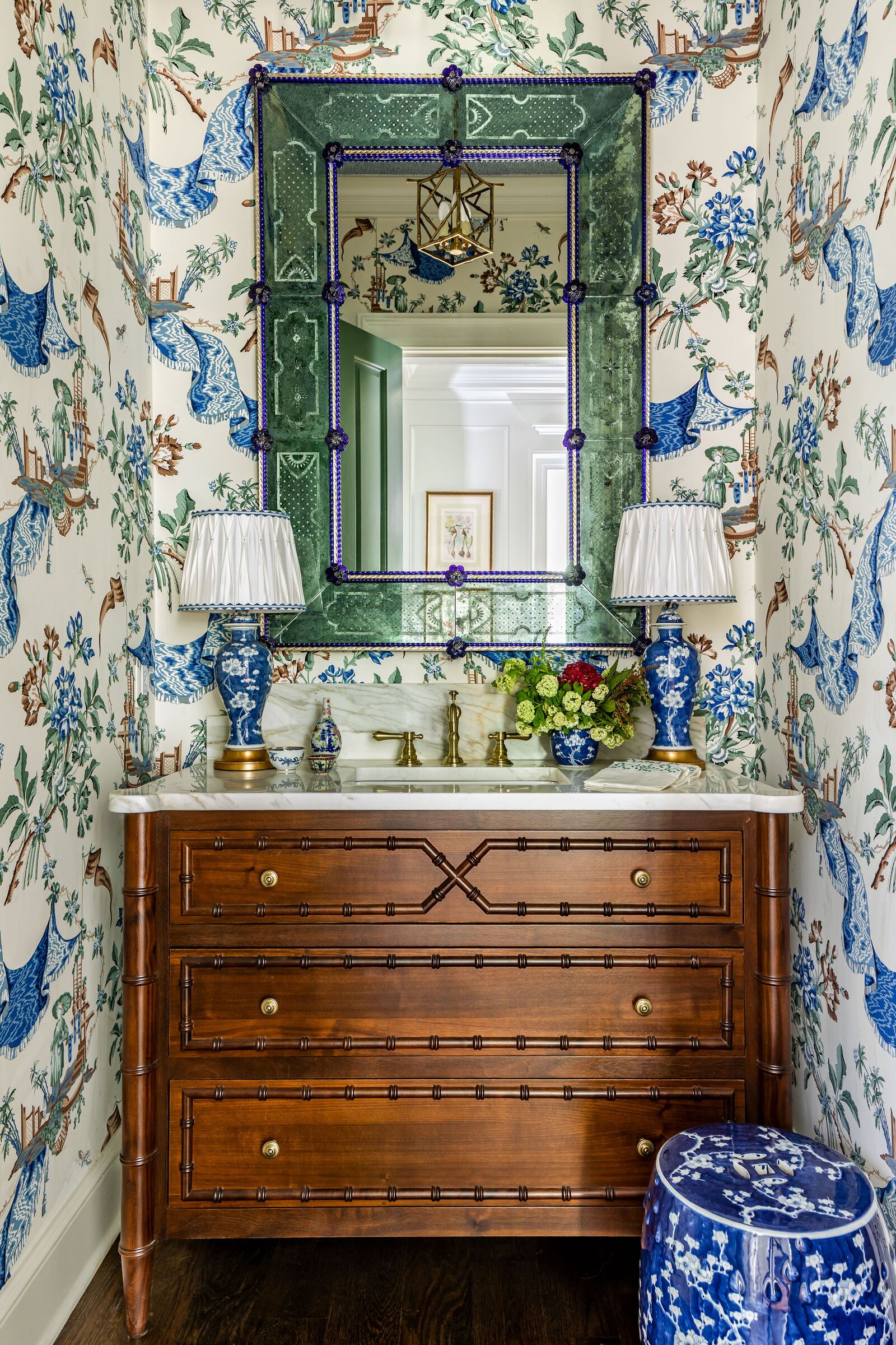 Atlanta interior designer Mallory Mathison Glenn says that details like custom lampshades, painted ceilings and the right wallpaper can help bring a maximalist space like this powder room together. Photo: Courtesy of Mallory Mathison Inc. / Jeff Herr