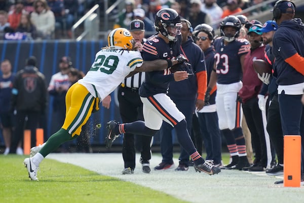 Chicago Bears' Caleb Williams is stopped by Green Bay Packers' Xavier McKinney during the first half of an NFL football game Sunday, Nov. 17, 2024, in Chicago. McKinney was called for a penalty on the play. (AP Photo/Nam Y. Huh)