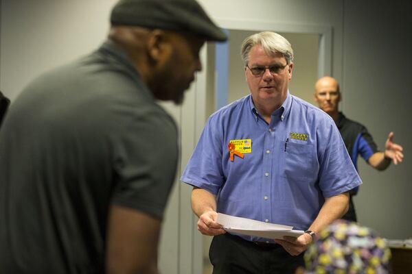 04/30/2018 — Norcross, GA - Waffle House spokesperson Pat Warner, center, passes out a statement to protestors during an impromptu press conference at the Waffle House corporate campus headquarters in Norcross, Monday, April 30, 2018. ALYSSA POINTER/ALYSSA.POINTER@AJC.COM