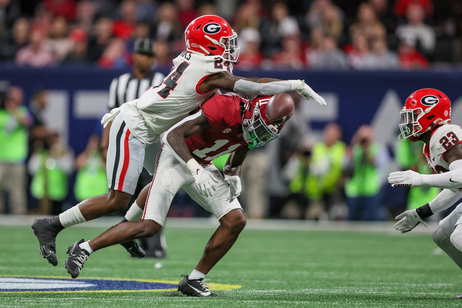 Georgia Bulldogs defensive back Malaki Starks (24) blocks Alabama Crimson Tide wide receiver Malik Benson (11) during the first half of the SEC Championship football game at the Mercedes-Benz Stadium in Atlanta, on Saturday, December 2, 2023. (Jason Getz / Jason.Getz@ajc.com)