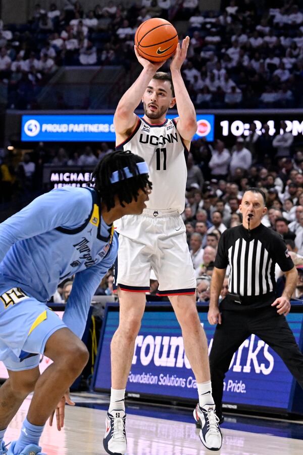 UConn forward Alex Karaban (11) shoots against Marquette during the second half of an NCAA college basketball game, Wednesday, March 5, 2025, in Storrs, Conn. (AP Photo/Jessica Hill)