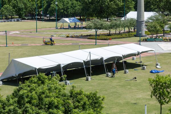 Classic Tents and Events workers erect tents Tuesday for the Atlanta City Games that will be held in  Centennial Olympic Park on Saturday, May 6.  (Steve Schaefer/steve.schaefer@ajc.com)