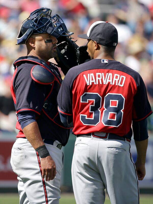 Atlanta Braves catcher Gerald Laird, left, speaks with pitcher Anthony Varvaro in the fifth inning of a spring exhibition baseball game against the Boston Red Sox, Friday, March 7, 2014, in Fort, Myers, Fla. The Red Sox won 4-1.