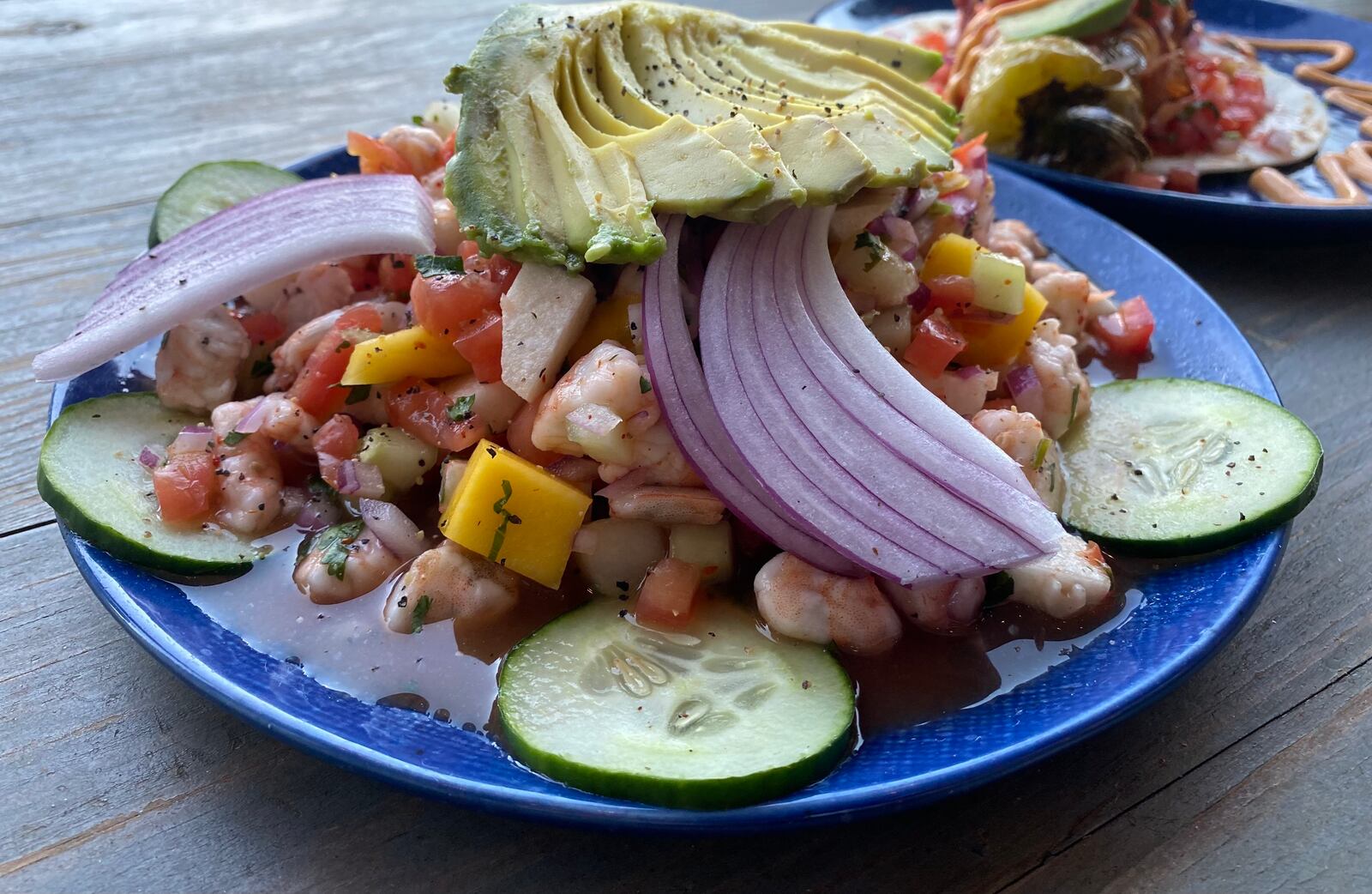 The muchacho alegre ceviche at El Capitan features lime juice-cured shrimp with mango, tomato, cucumber, onion and jicama. Ligaya Figueras/ligaya.figueras@ajc.com