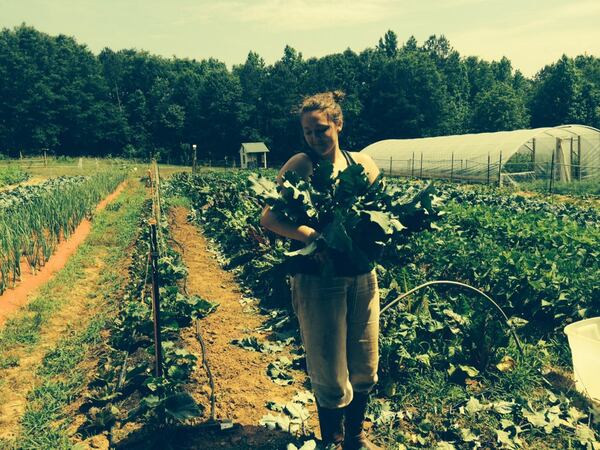 Hannah Lee with some of the fresh-picked bounty that visitors to the Georgia Mountains Farm Tour will likely see. Aspiring farmer Lee is learning the ins-and-outs of organic farming while working at Taylor Creek Farm in Toccoa. JILL VEJNOSKA / JVEJNOSKA@AJC.COM