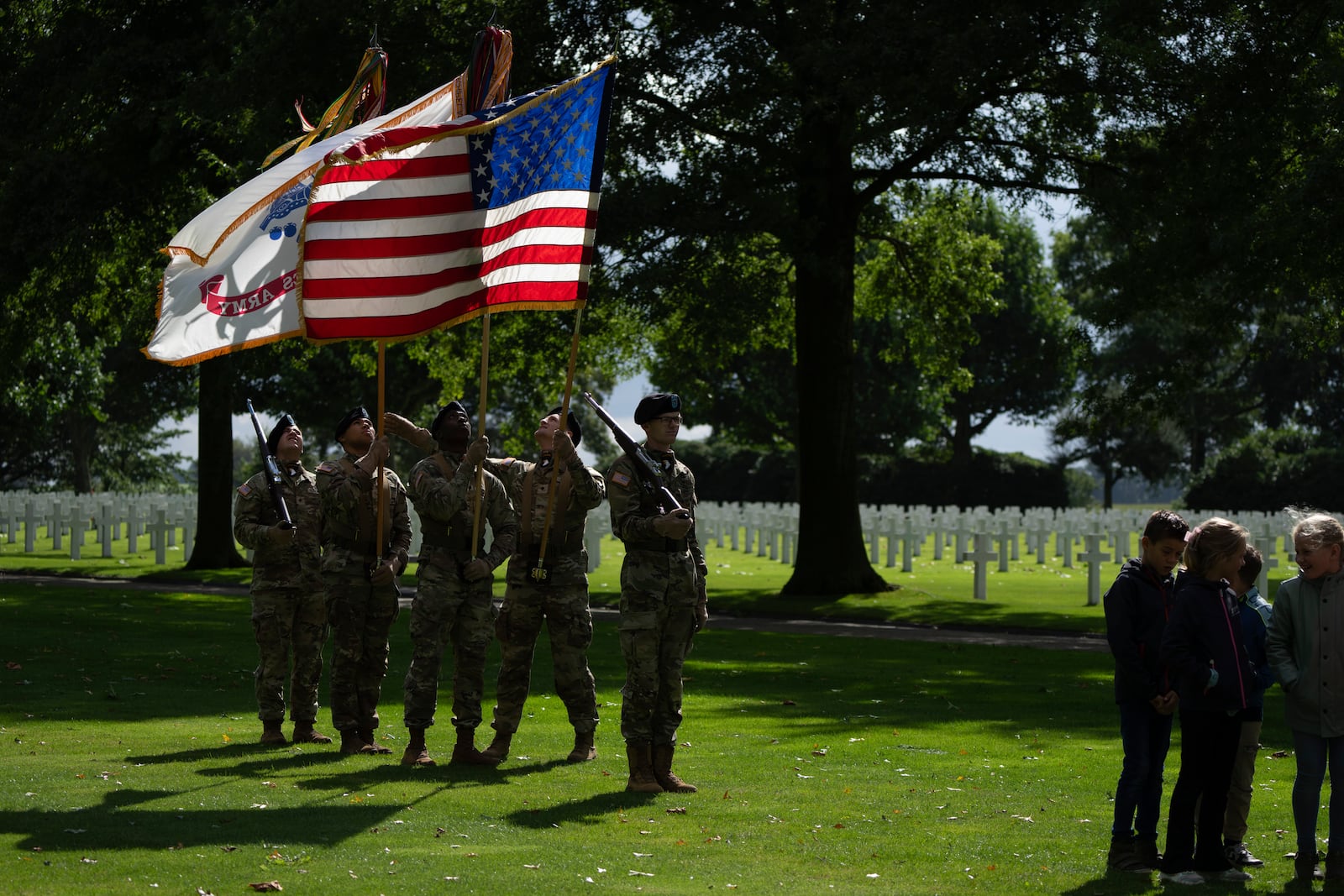 Flag bearers of the the 101st Airborne Division, known as Screaming Eagles, out of Fort Campbell, Kentucky, rehearse for a commemoration eighty years after the liberation of the south of the Netherlands at the Netherlands American Cemetery in Margraten, southern Netherlands, on Wednesday, Sept. 11, 2024. (AP Photo/Peter Dejong)