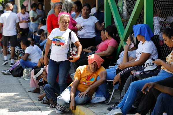 Relatives of those who were detained during a government crackdown following anti-government protests against the results of the presidential election, wait outside the Yare 3 prison in San Francisco de Yare, Venezuela, Saturday, Nov. 16, 2024, after Attorney General Tarek William Saab announced the release of some. (AP Photo/Cristian Hernandez)