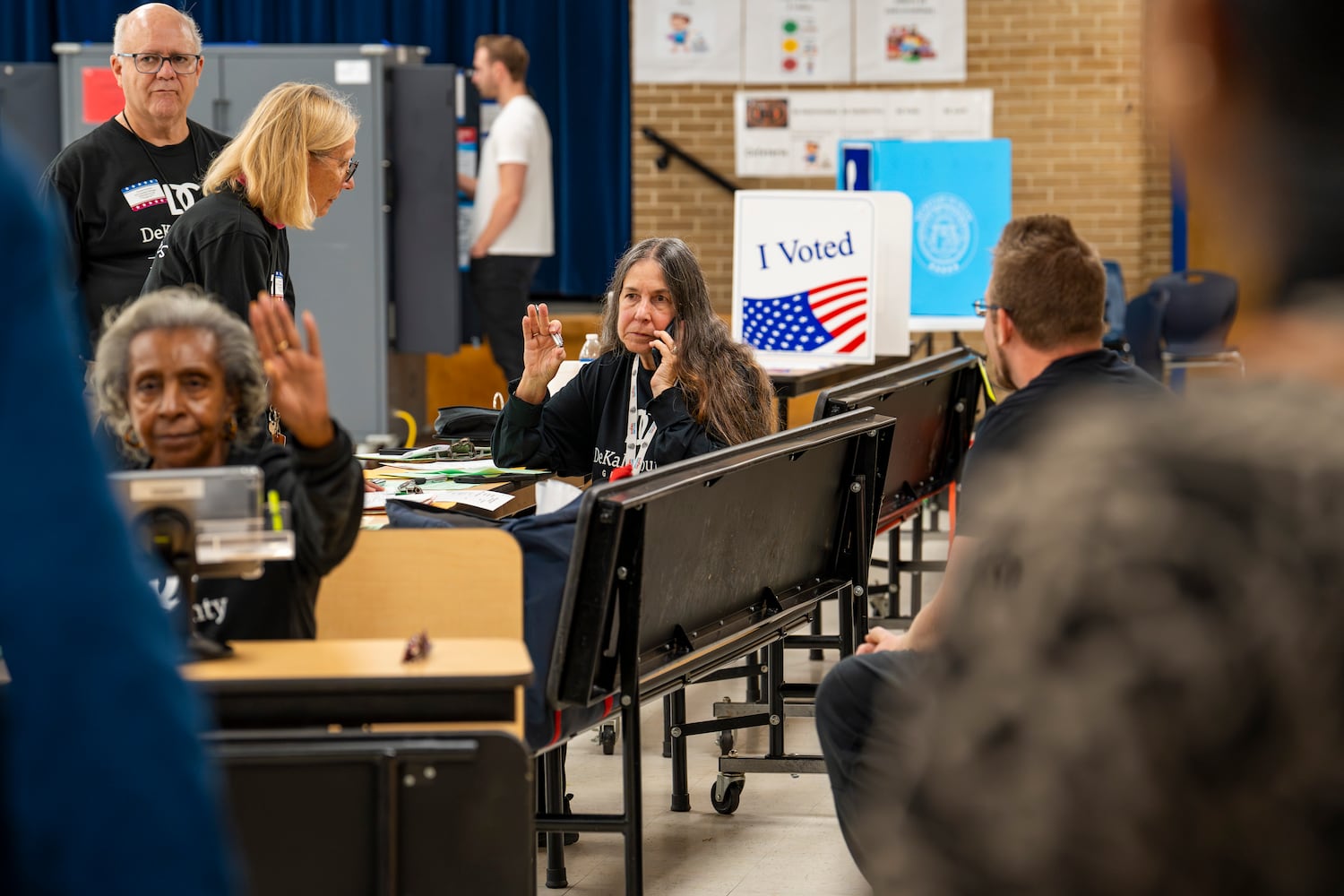 A poll worker calls the Georgia Secretary of State's office to determine if it's too late for a man to register to vote on election day  at a polling site in Chamblee,  Tuesday, Nov. 5, 2024. (Olivia Bowdoin for the AJC). 