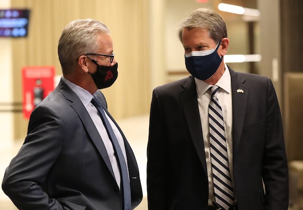 Gov. Brian Kemp confers with Steve Cannon, CEO AMB Sports & Entertainment as they arrive along with members of the Federal Emergency Management Agency (FEMA), the Georgia Emergency Management Agency (GEMA), Fulton County Board of Health and Fulton County as operations get under way for Mercedes-Benz Stadium to become the largest Community Vaccination Center in the southeast serving an average of 42,000 citizens a week on Tuesday, March 23, 2021, in Atlanta.  Curtis Compton / Curtis.Compton@ajc.com