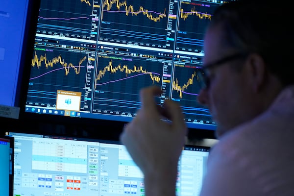 People work on the floor at the New York Stock Exchange in New York, Monday, Feb. 24, 2025. (AP Photo/Seth Wenig)