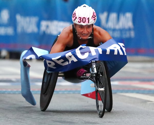 Manuela Schar wins the women's wheelchair race in record time and a $50,000 bonus during the 50th AJC Peachtree Road Race on Thursday, July 4, 2019, in Atlanta.  Curtis Compton/ccompton@ajc.com