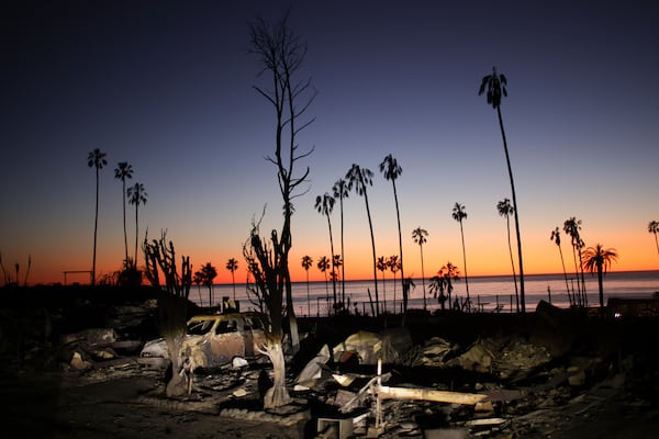 The devastation of the Palisades Fire is seen at sunset in the Pacific Palisades neighborhood of Los Angeles, Tuesday, Jan. 14, 2025. (AP Photo/Ethan Swope)