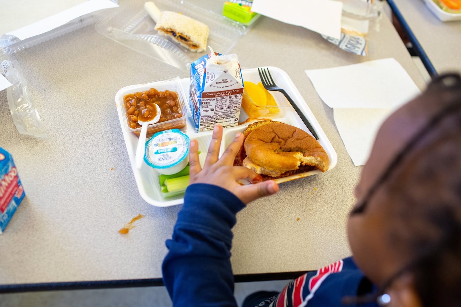 A student at Hickory Hills Elementary School in Marietta eats lunch on Jan. 21, 2020. All students at the school used to get free meals, but declining poverty rates led the school system to exit the U.S. Department of Agriculture program. Still, about 69% of students there — 60% in the district as a whole — are entitled to a free or reduced-price meal if their parents fill out the paperwork, though that doesn’t always happen. Students who accrue too much debt are fed an alternate lunch with a cheese sandwich. 