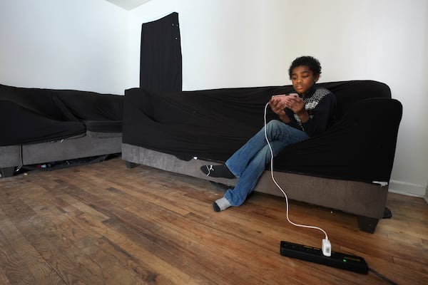 Joseph Hardaway V, 12, watches a phone at home in Detroit, Monday, Feb. 17, 2025. (AP Photo/Paul Sancya)