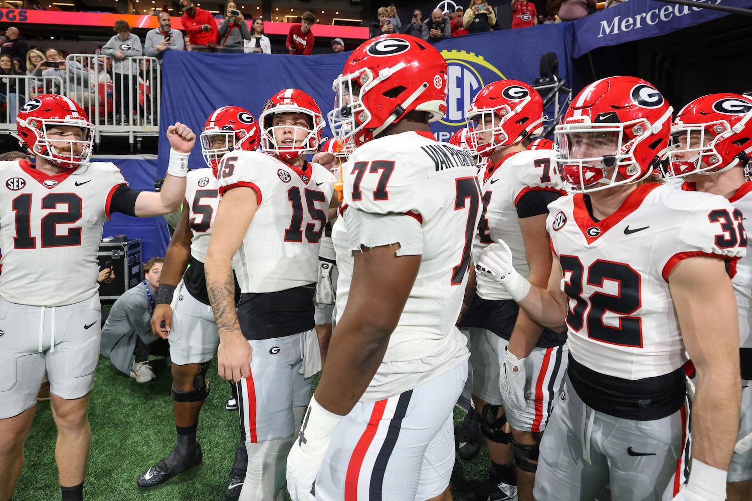 Georgia Bulldogs offensive lineman Sedrick Van Pran (77) wears the jersey number of Devin Willock, a tribute to the player who was killed in a January car crash, before facing the Alabama Crimson Tide in the SEC Championship football game at the Mercedes-Benz Stadium in Atlanta, on Saturday, December 2, 2023. (Jason Getz / Jason.Getz@ajc.com)