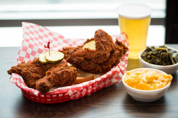 Hattie B's Hot Chicken 1/2 Bird Plate served with two sides, bread, and pickles. Pictured are Pimento Mac and Cheese and Southern Greens sides with a draft beer. Photo credit- Mia Yakel.