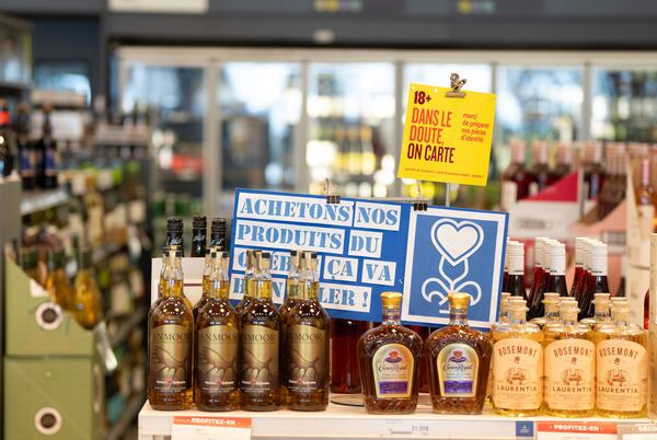 A sign in a local Societe des alcools du Quebec (SAQ) liquor store urges patrons to buy local Quebec-made products in Montreal on Monday, Feb. 3, 2025. (Christinne Muschi/The Canadian Press via AP)