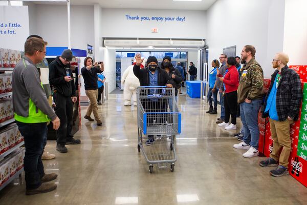 Walmart Greeters welcome back customers during the re-opening of Walmart in Peachtree City, Georgia, on Wednesday, December 21, 2022. The store reopened after burning down in August 2022. CHRISTINA MATACOTTA FOR THE ATLANTA JOURNAL-CONSTITUTION.