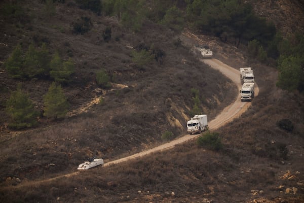 A convoy of the United Nations peacekeeping forces in Lebanon (UNIFIL) drives on area along the Israeli-Lebanese border as seen from northern Israel, Friday, Nov. 29, 2024. (AP Photo/Leo Correa)