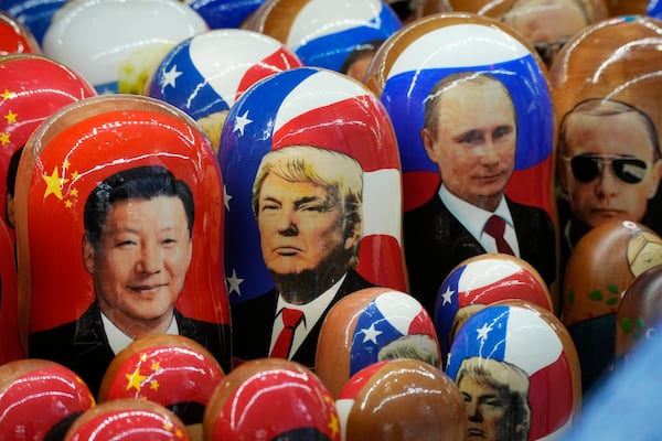 FILE - Traditional Russian wooden dolls depicting China's President Xi Jinping, U.S. President-elect Donald Trump and Russian President Vladimir Putin are displayed for sale at a souvenir shop in St. Petersburg, Russia, Nov. 21, 2024. (AP Photo/Dmitri Lovetsky, File)